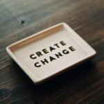 A white tray with the words create change written on it