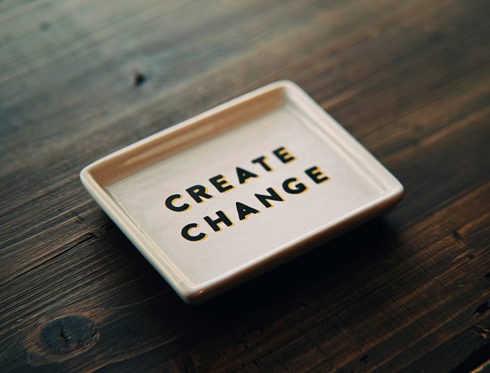 A white tray with the words create change written on it