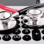 a stethoscope sitting on top of a calculator